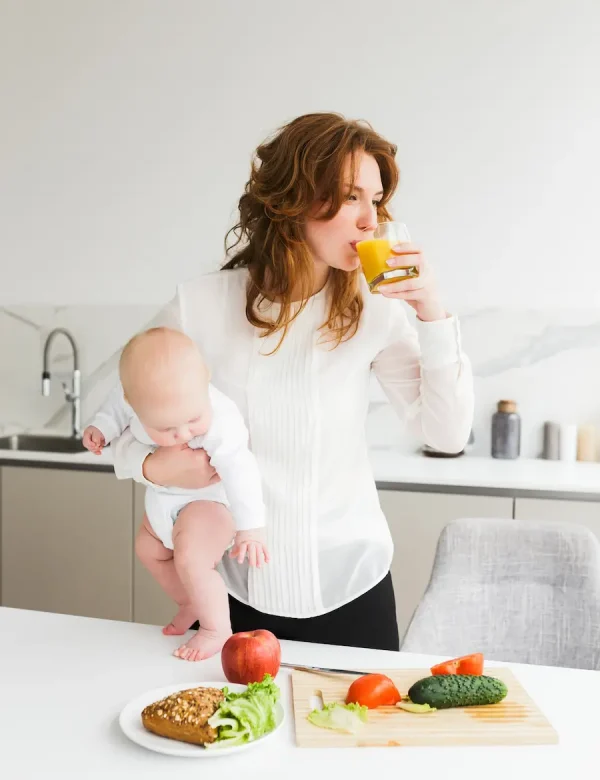 portrait-young-pretty-woman-standing-holding-her-little-baby-while-drinking-juice-cooking-kitchen portrait-young-pretty-woman-standing-holding-her-little-baby-while-drinking-juice-cooking-kitchen
