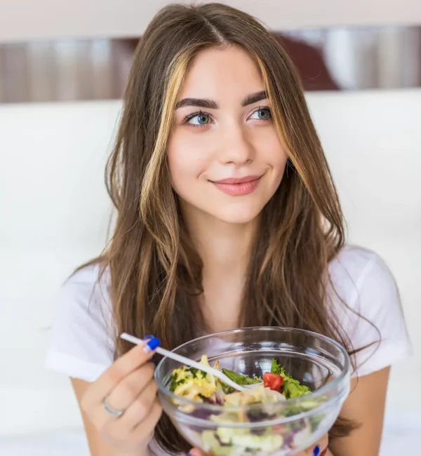 young-beautiful-woman-vegetarian-eating-fresh-green-salad-home